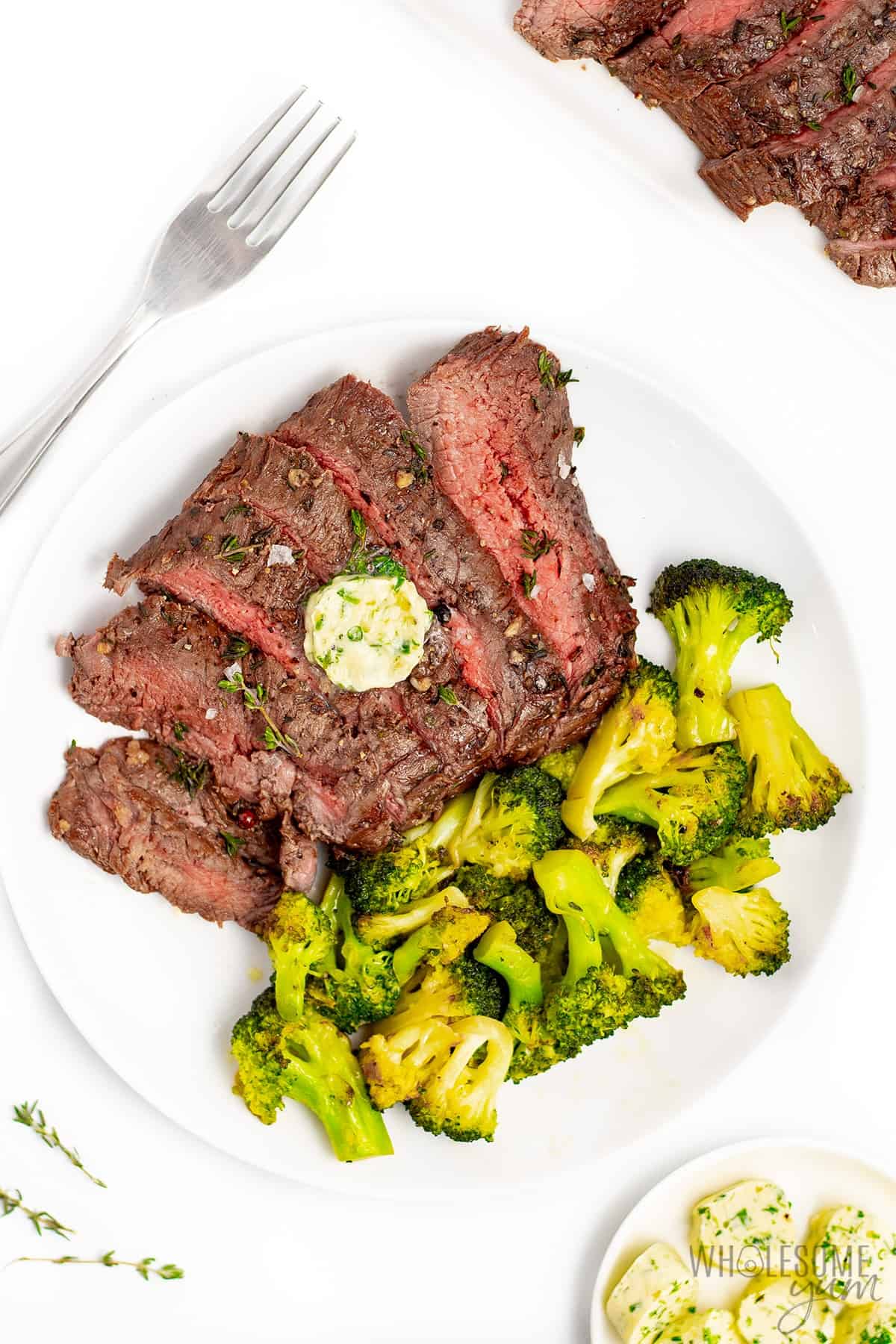 London broil steak on a plate with broccoli