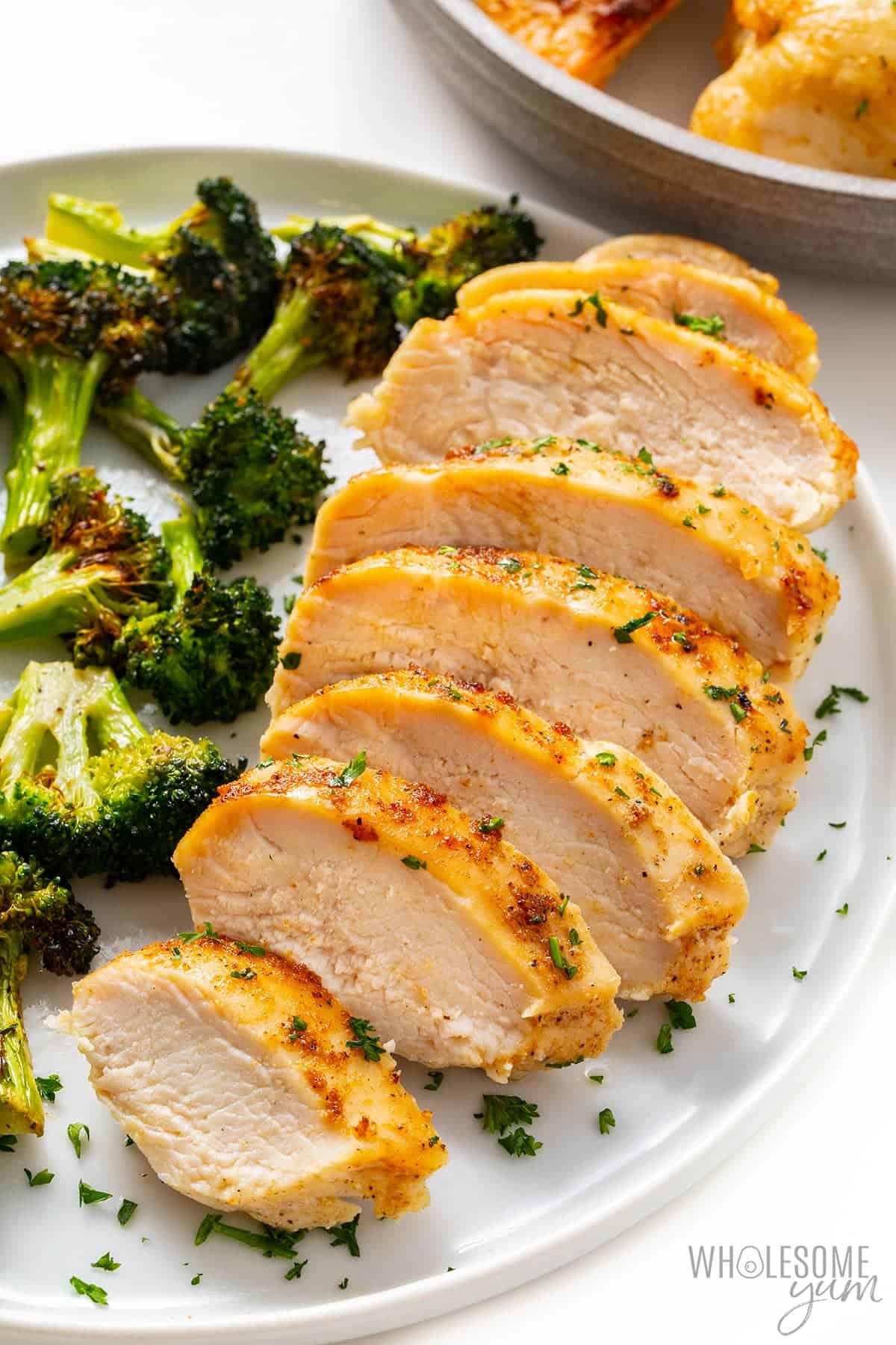 Air fryer chicken breast with broccoli on a plate