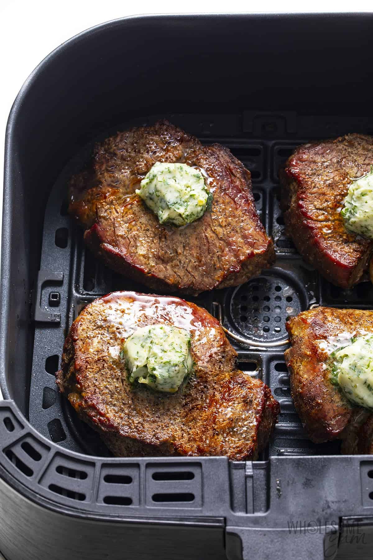 Filet mignon steaks in air fryer with compound butter
