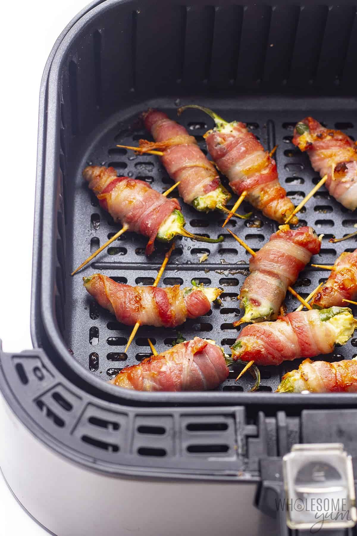 Cooked bacon wrapped jalapeno poppers in air fryer
