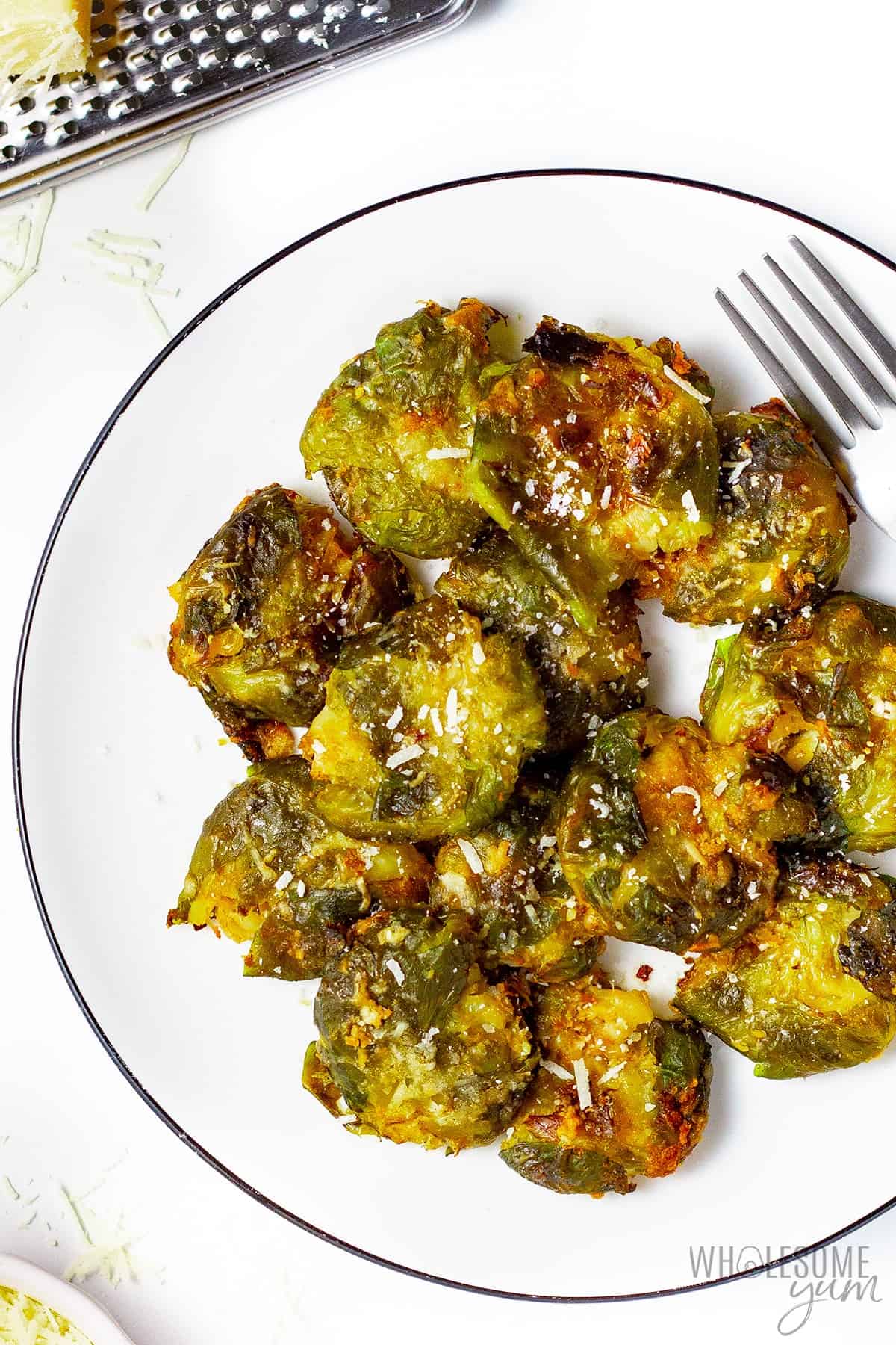 Crispy smashed brussels sprouts with parmesan on a plate.