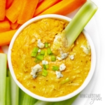 Instant Pot buffalo chicken dip recipe in a bowl with celery.