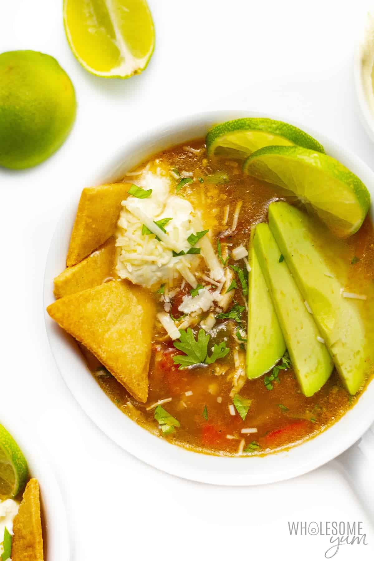 Bowl of low carb chicken tortilla soup with toppings