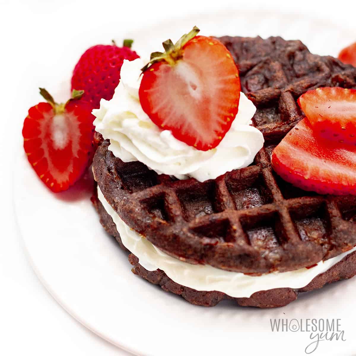 Chocolate low carb chaffle with cream cheese frosting and strawberries