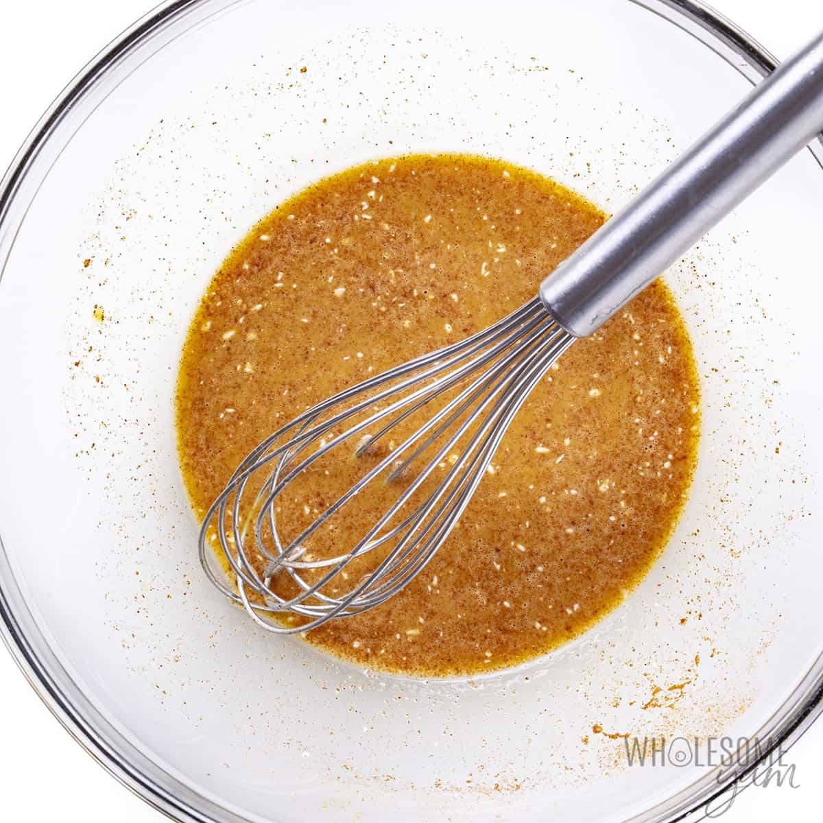Egg mixture in bowl with whisk