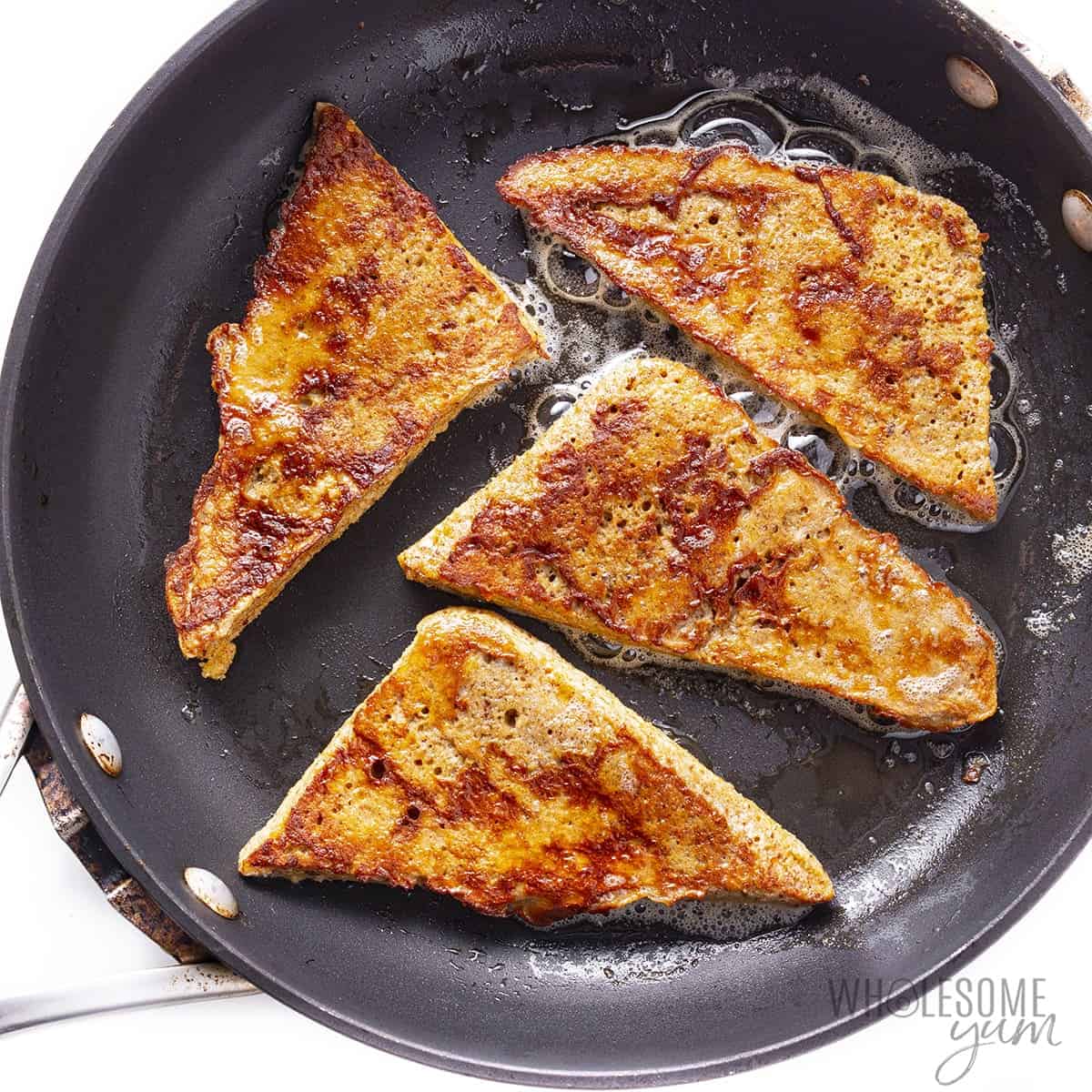 Keto French toast cooking in pan