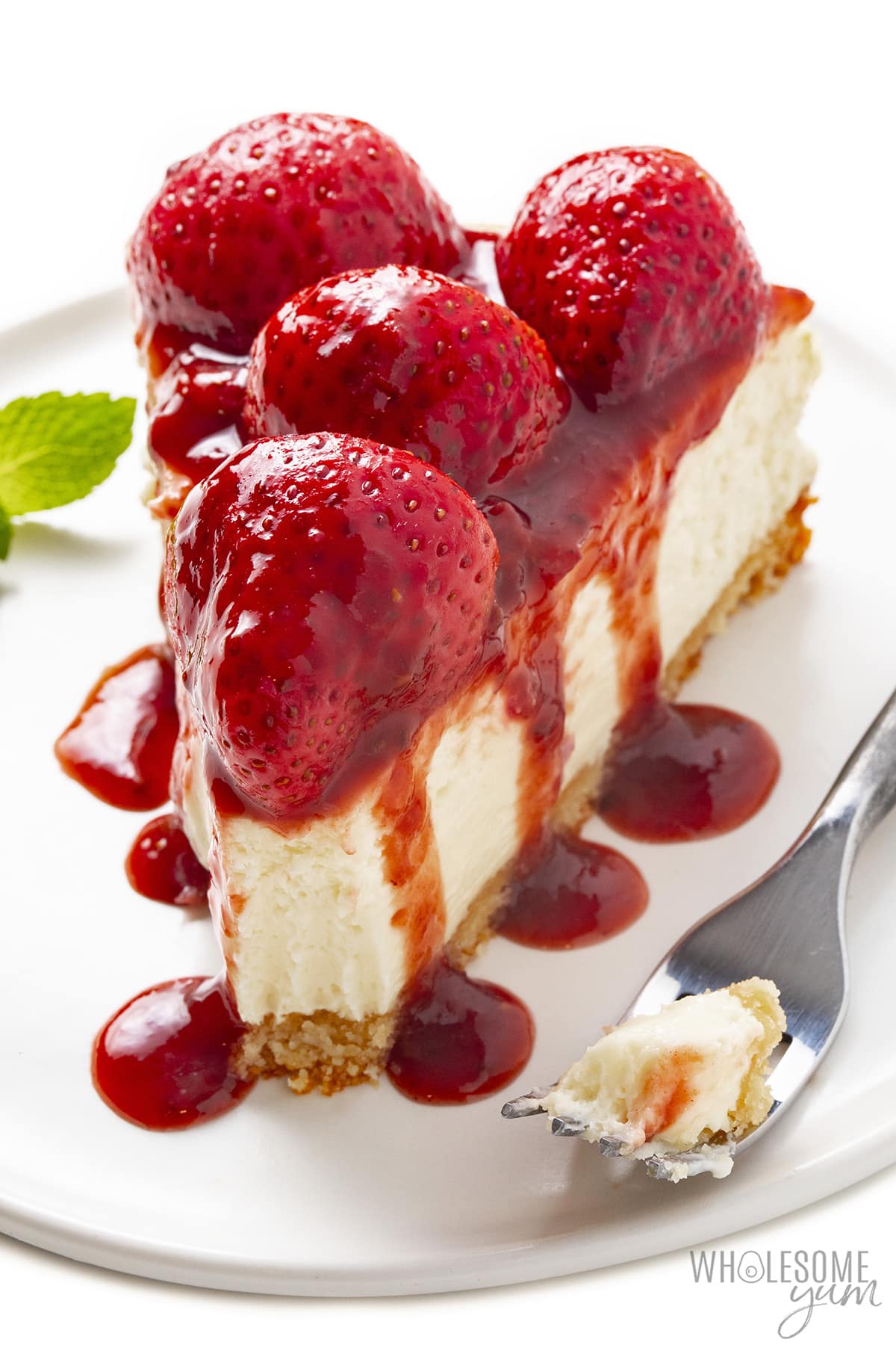 Sugar-free strawberry cheesecake slice on a place with fork.