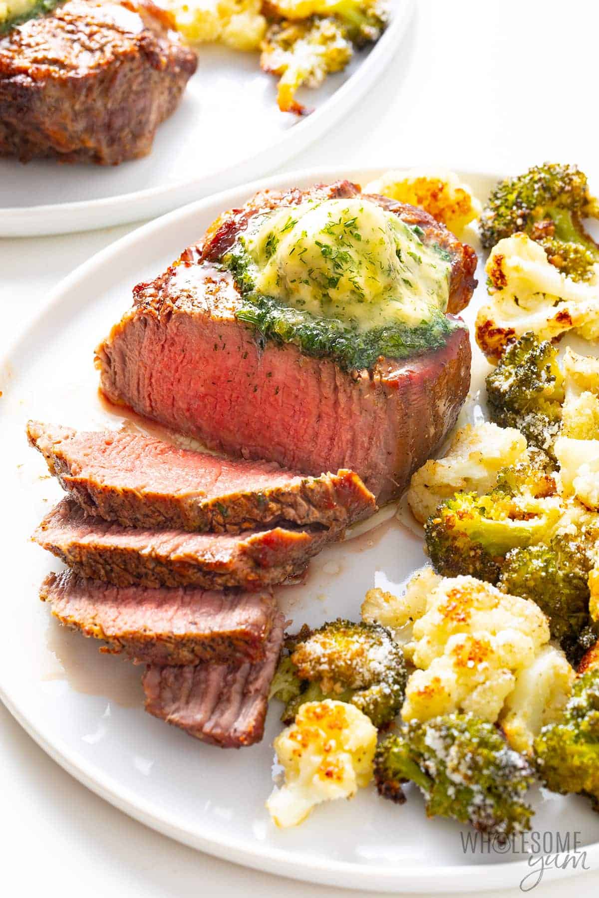 Air fried filet mignon with broccoli and cauliflower on plates
