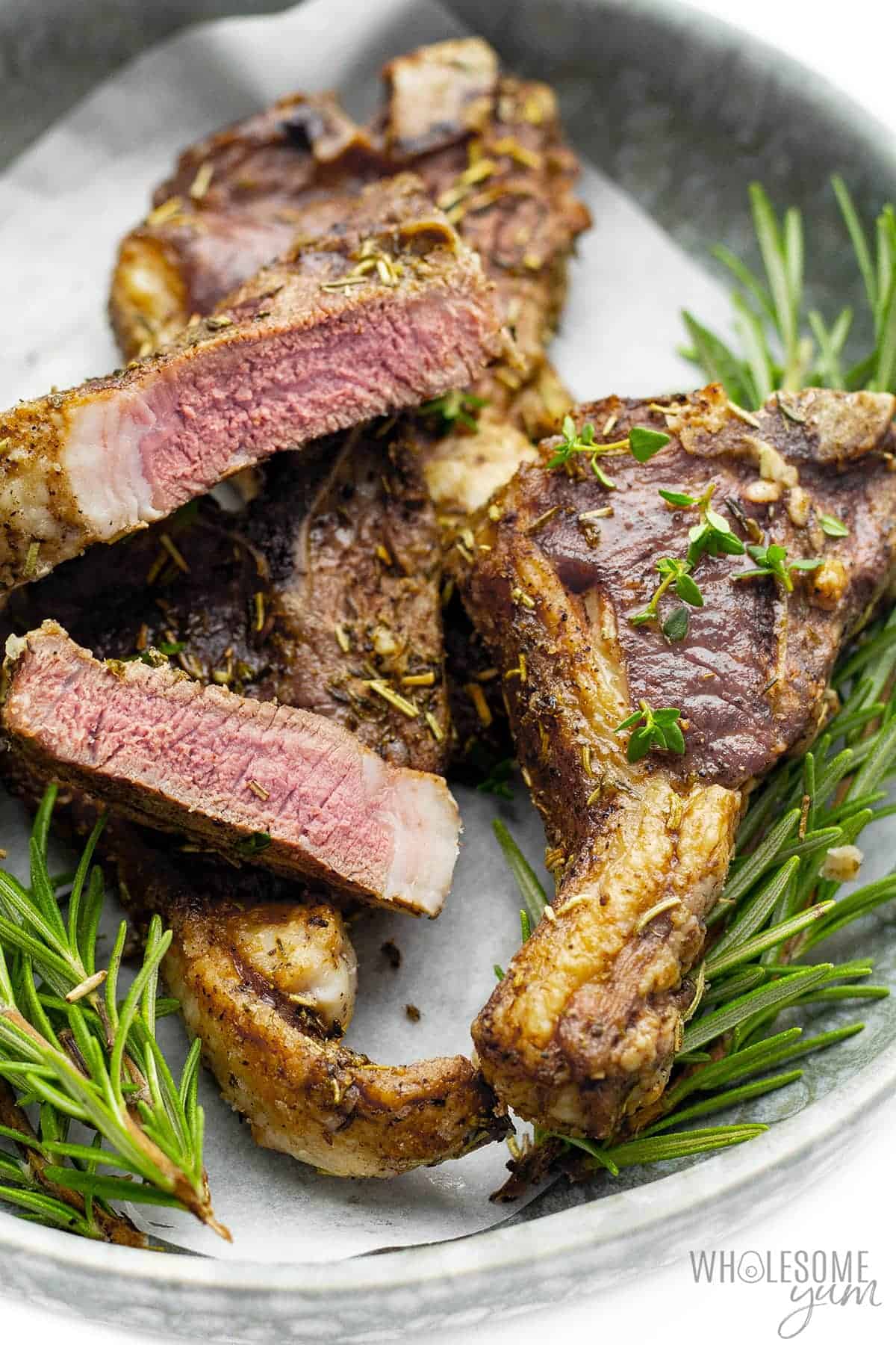 Air fried lamb chops with one chop sliced in half.