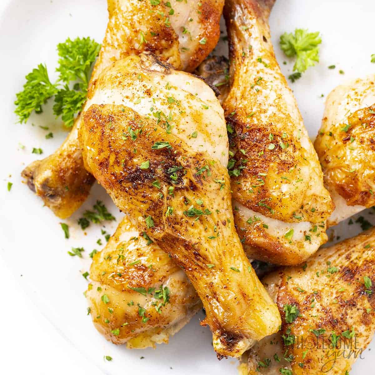 Baked chicken legs on a plate.