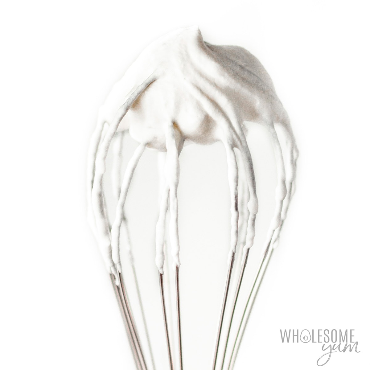 Sugar-free whipped cream on whisk.