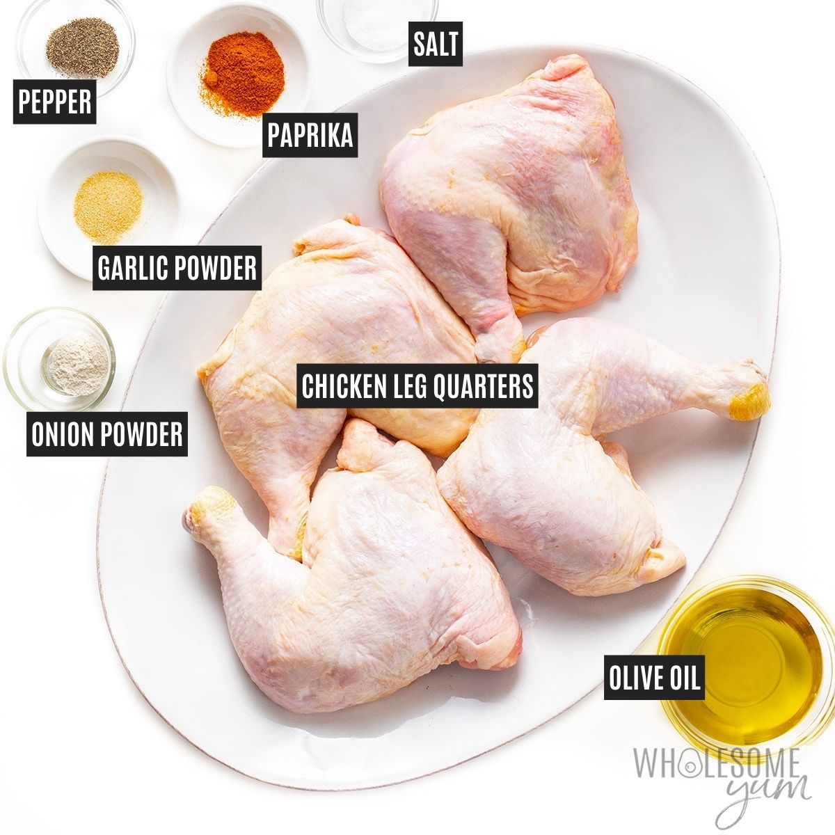 Chicken on a platter next to olive oil and seasonings in small bowls.