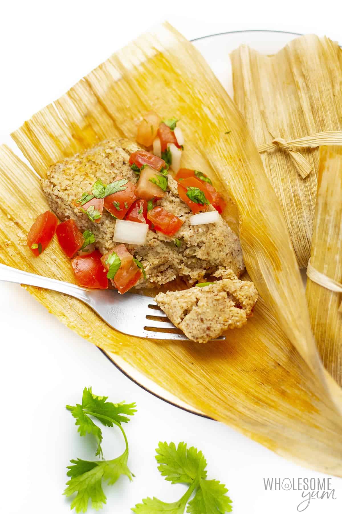Keto tamale on a plate with pico de gallo.