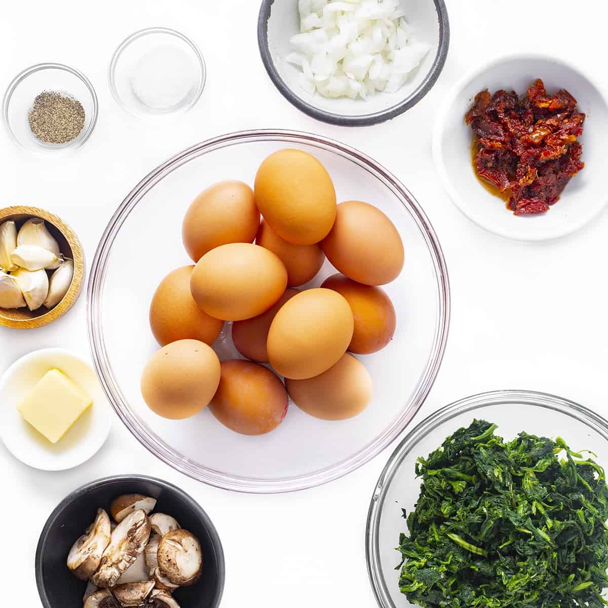 Ingredients to make baked eggs with veggies.