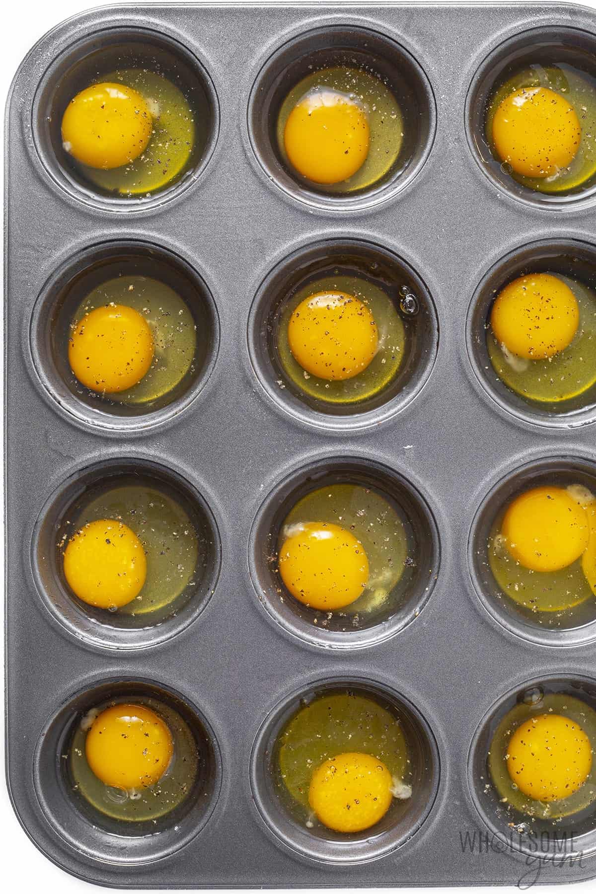 Raw eggs in muffin tin.