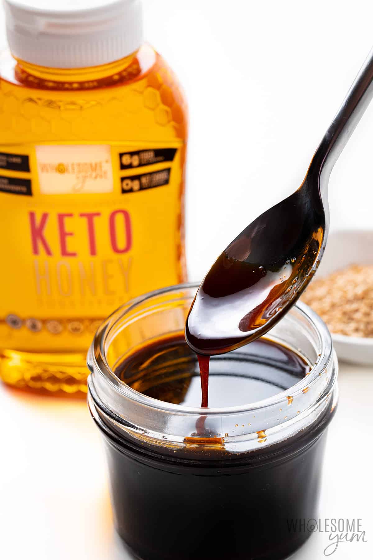 Low carb teriyaki sauce with a spoon and keto honey.