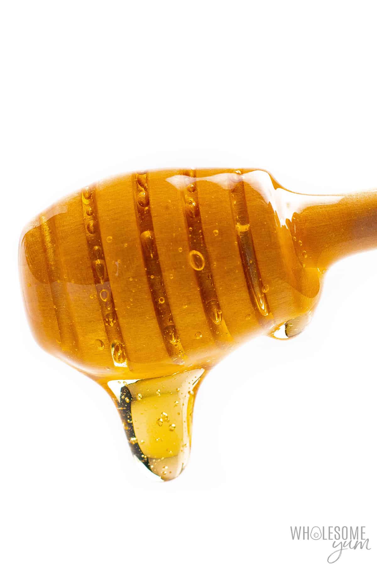 Honey dripping from a stirrer stick.