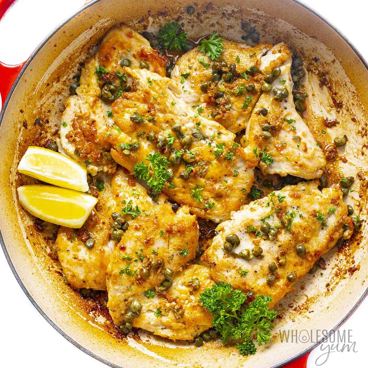 Finished chicken piccata recipe in pan with lemon.