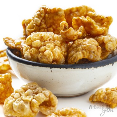 Side view of pork rinds piled in a bowl.