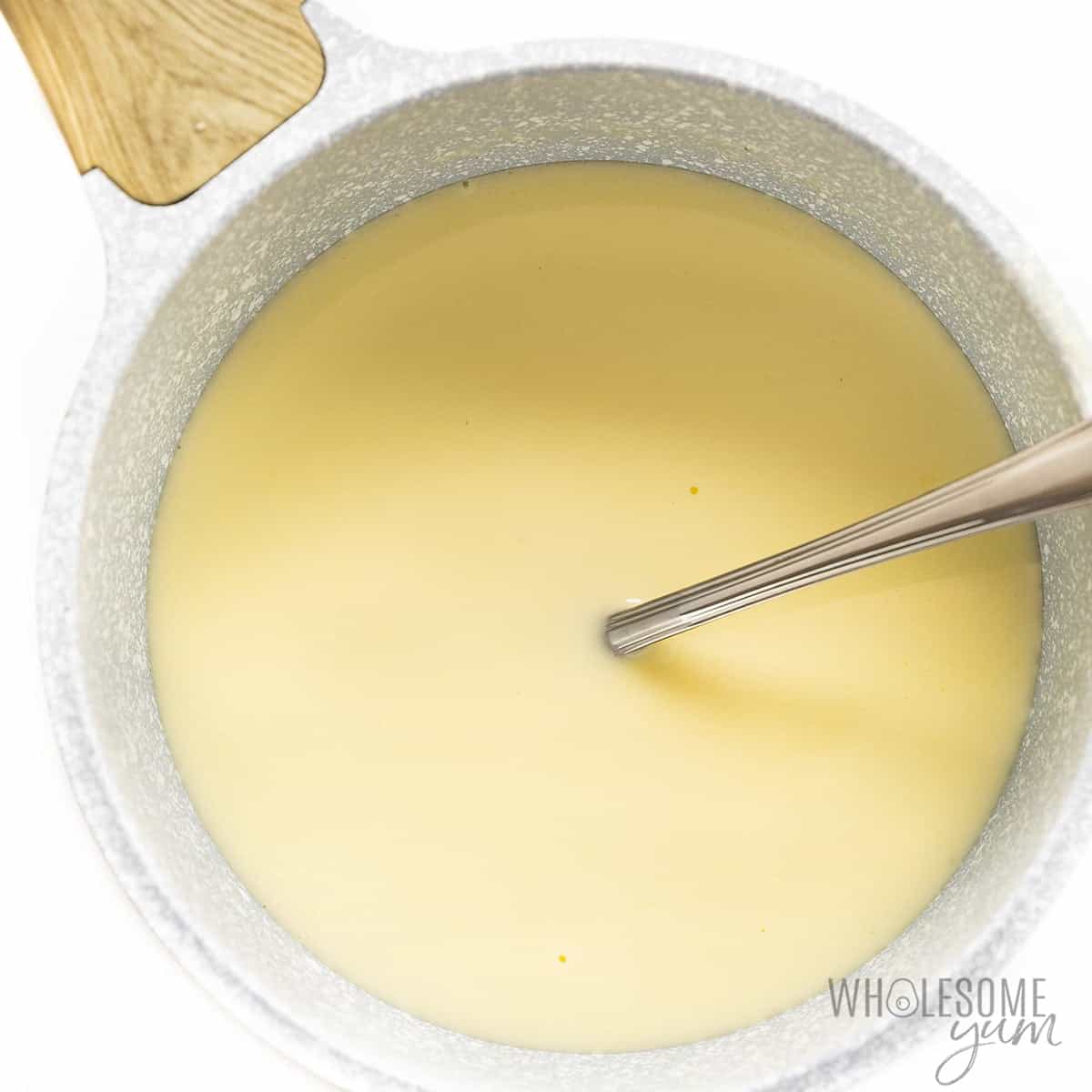 Cream heated in saucepan.