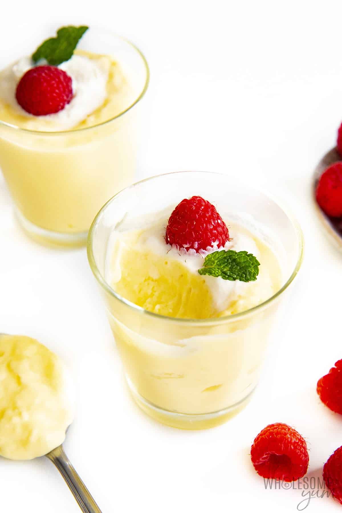 Keto vanilla pudding in a glass with a bite taken out.