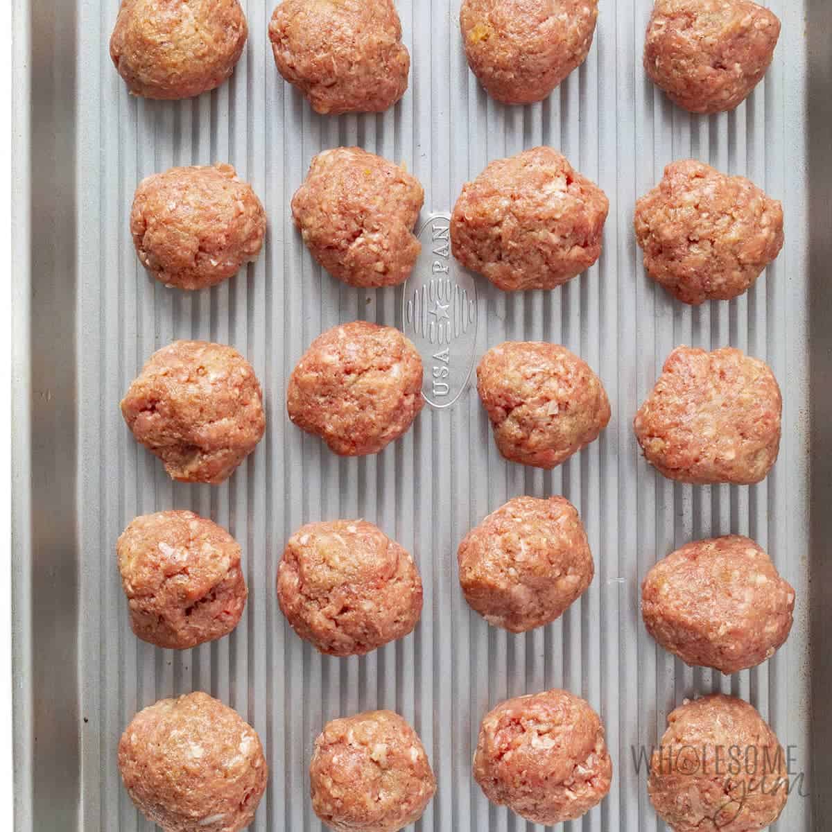 Formed meatballs on baking sheet.
