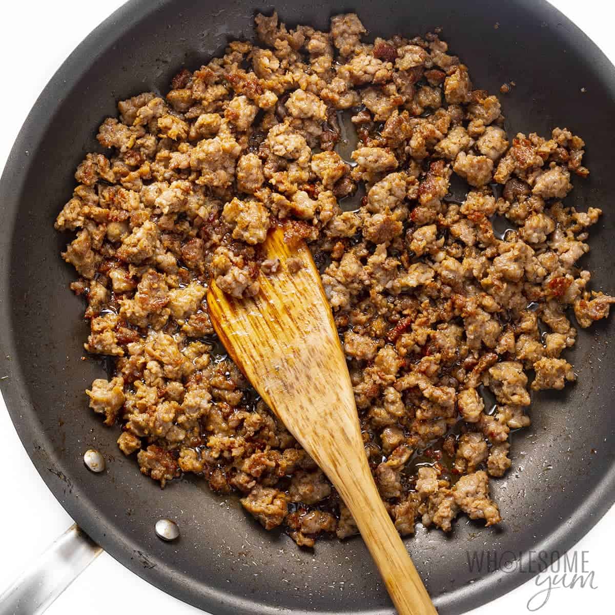 Browned Italian sausage in a skillet.