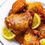 Juicy and crispy air fryer chicken thighs recipe on a plate.