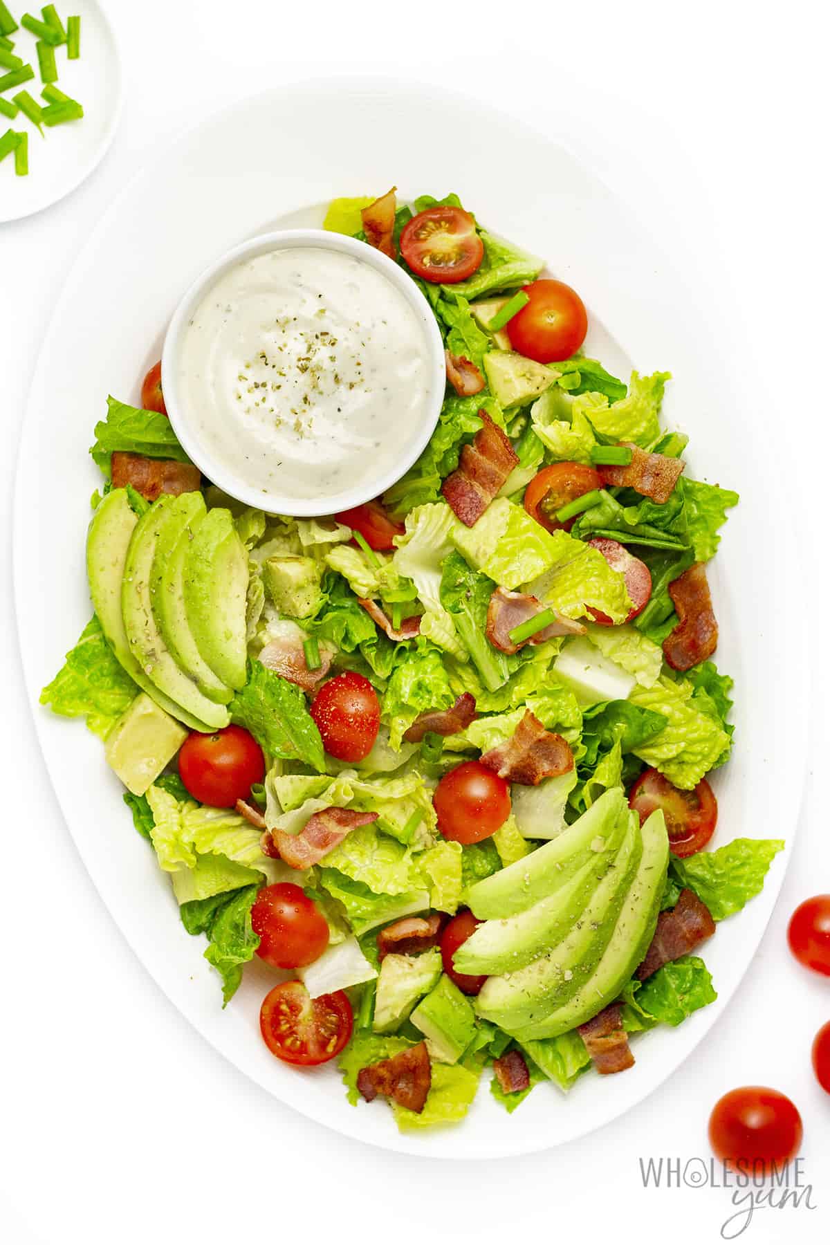 BLT salad on a platter with side of ranch dressing.