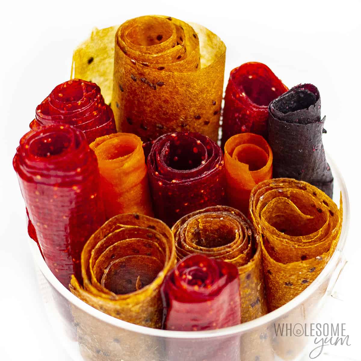 Assorted homemade fruit roll ups in a jar.