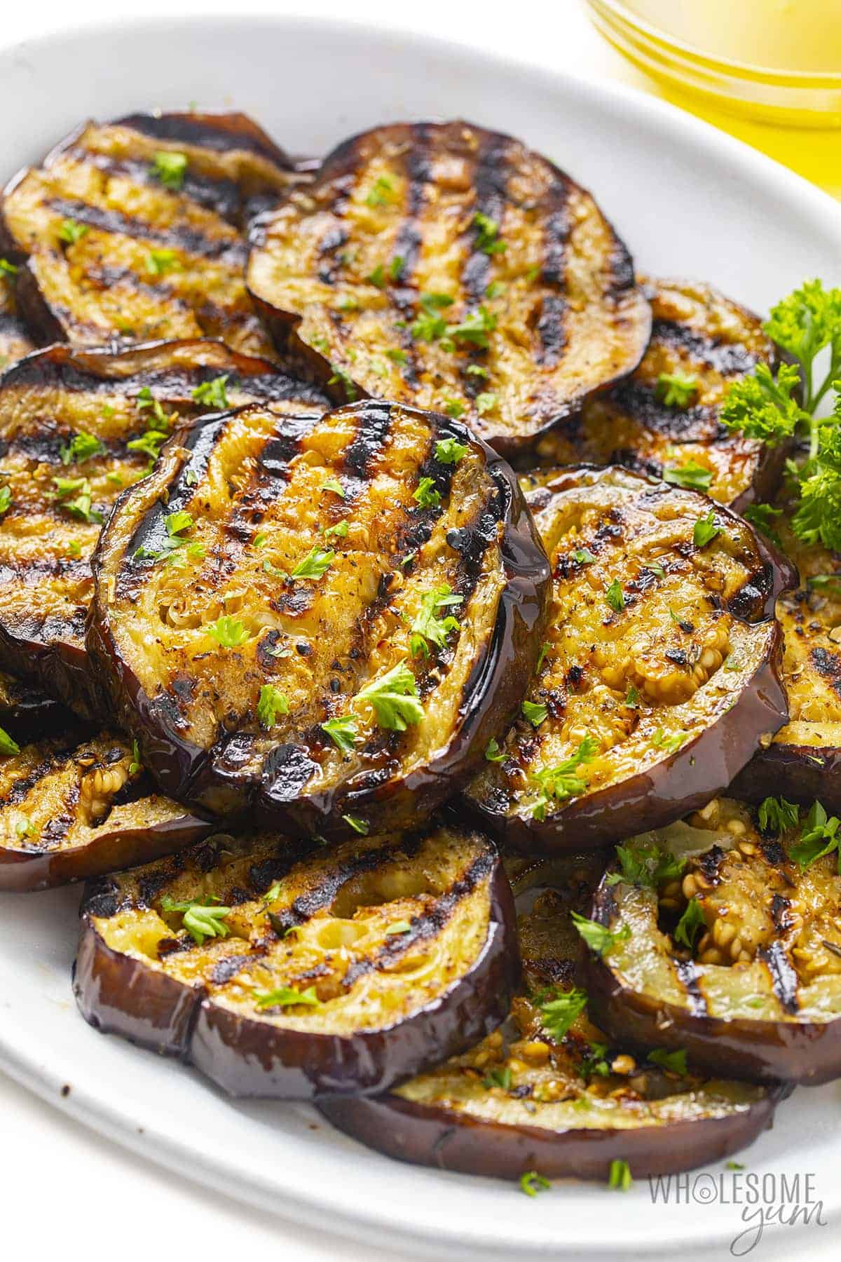 Eggplant with grill marks on a serving platter.