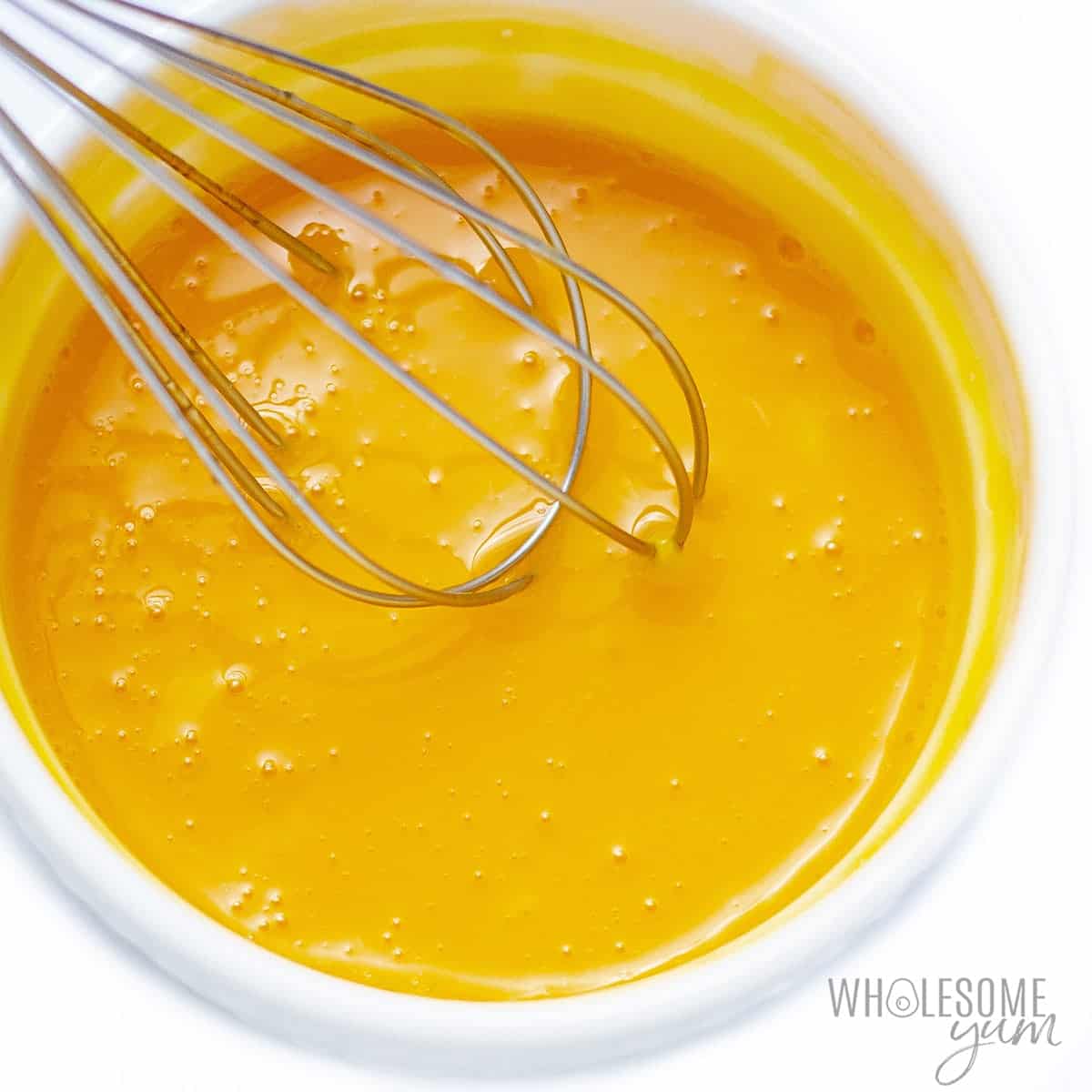 Whisk egg yolks in a bowl.