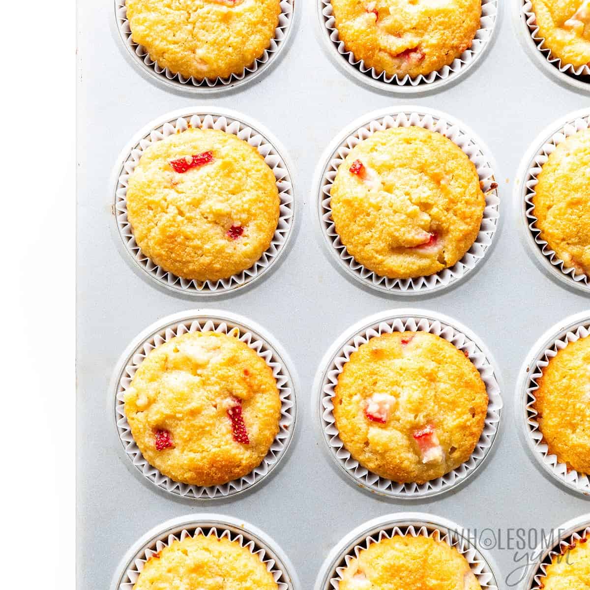 Fully baked almond flour muffins in muffin tin.