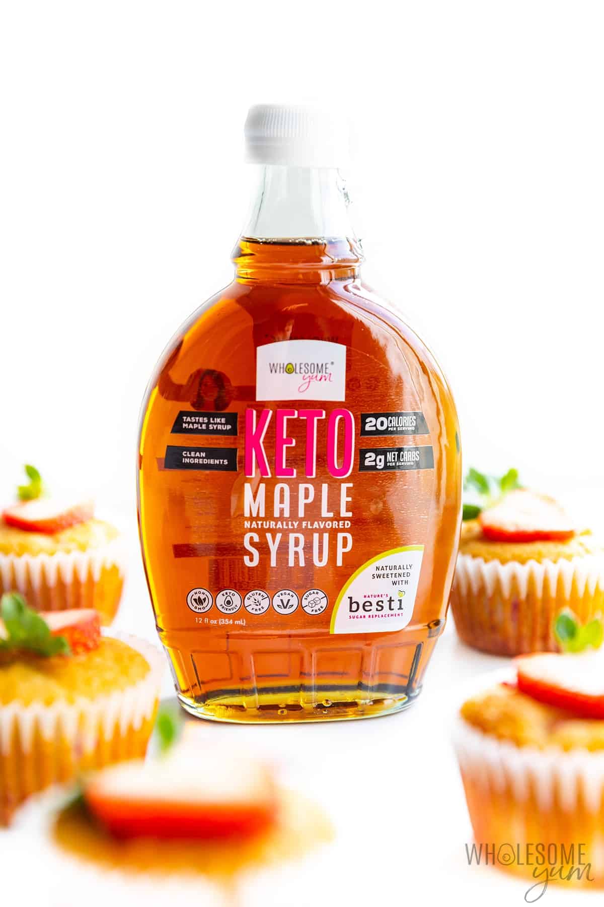 Almond flour muffins with a bottle of Wholesome Yum Keto Maple Syrup.
