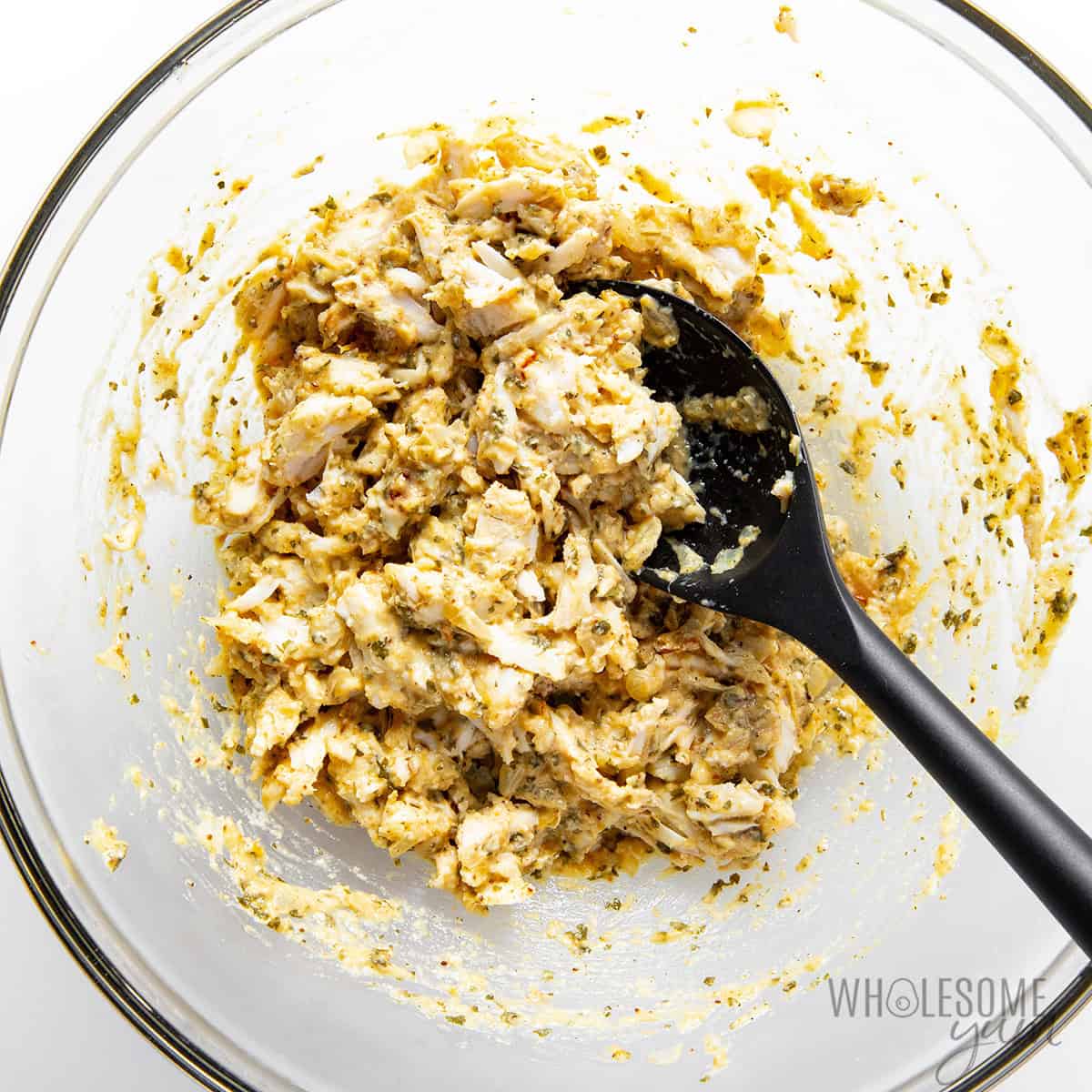 Lump crab meat folded into the bowl.