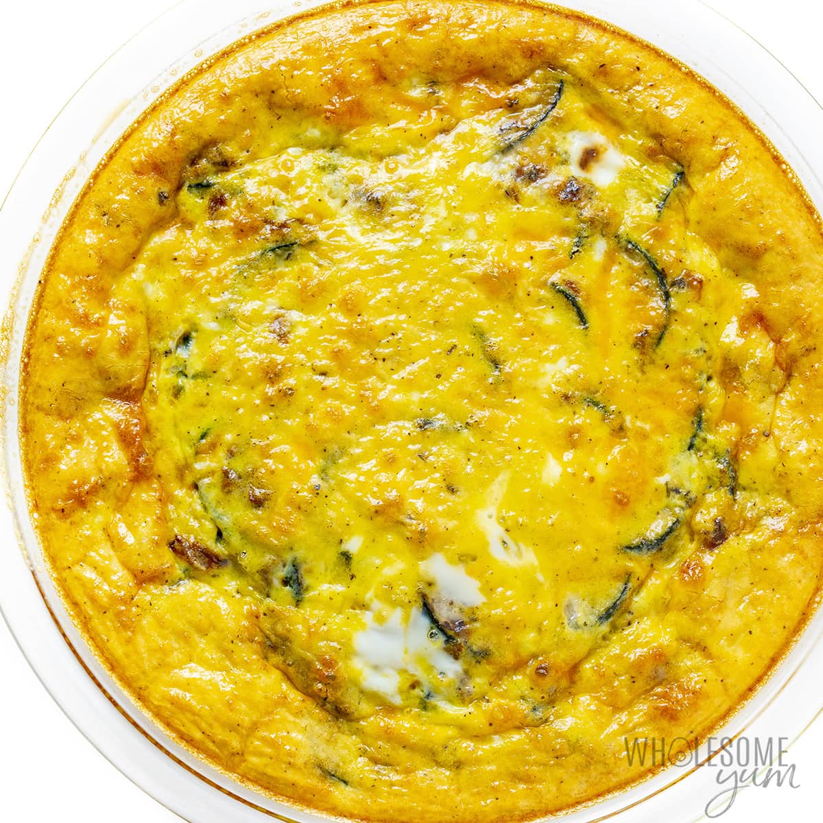 Fully baked zucchini quiche in pie plate.