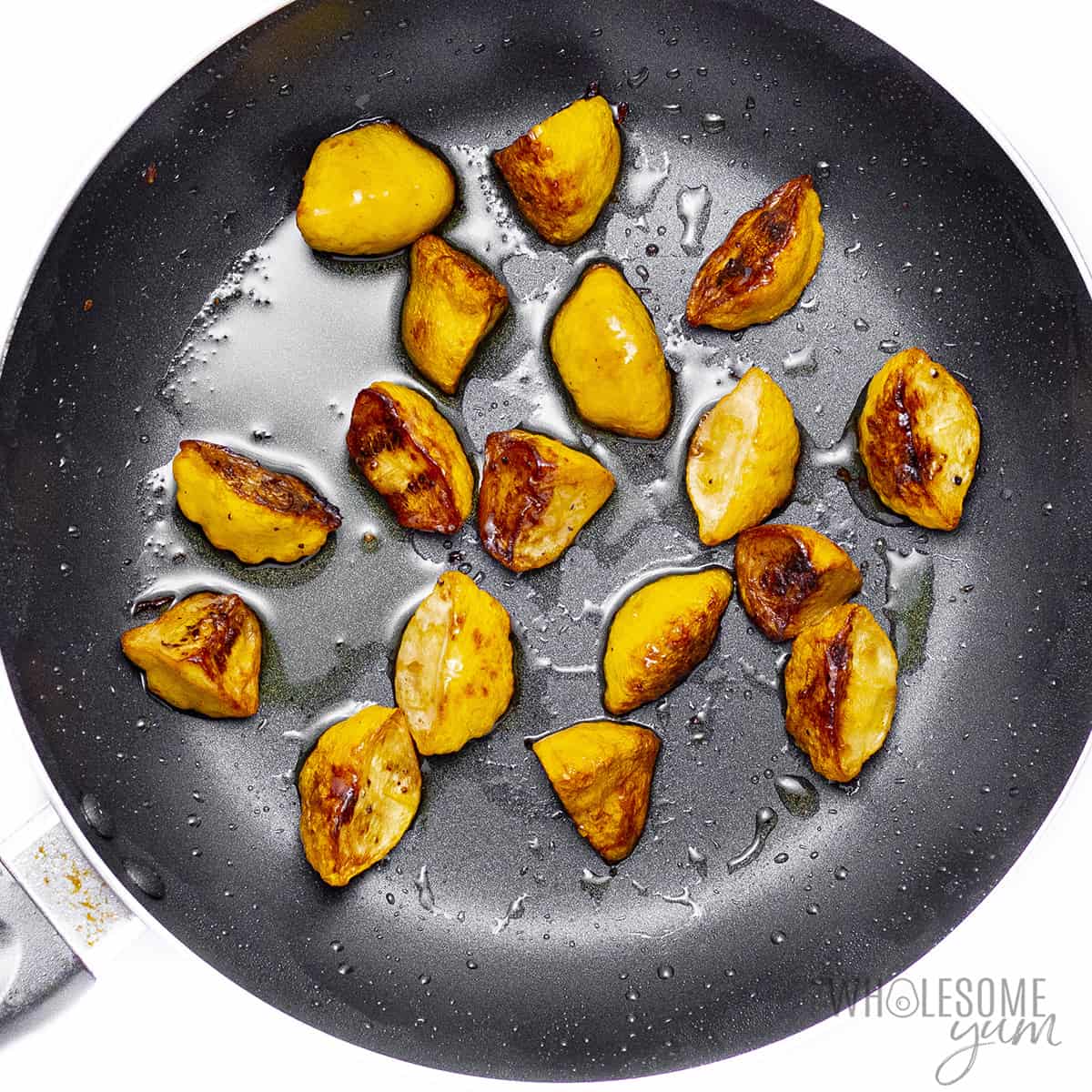 Fully cooked and sauteed patty pan squash recipe in skillet.
