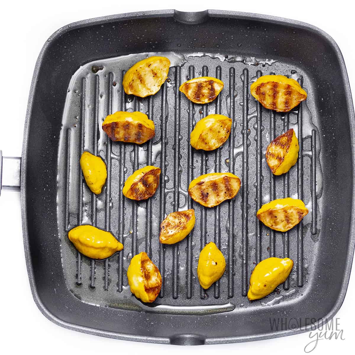 Patty pan squash in grill pan with grill marks.