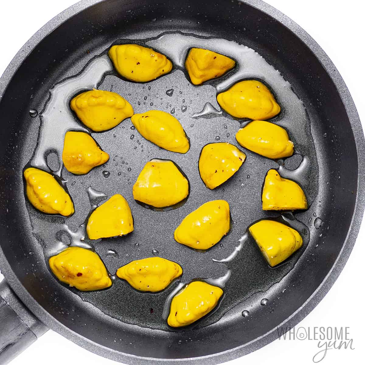 Patty pan squash in a skillet.