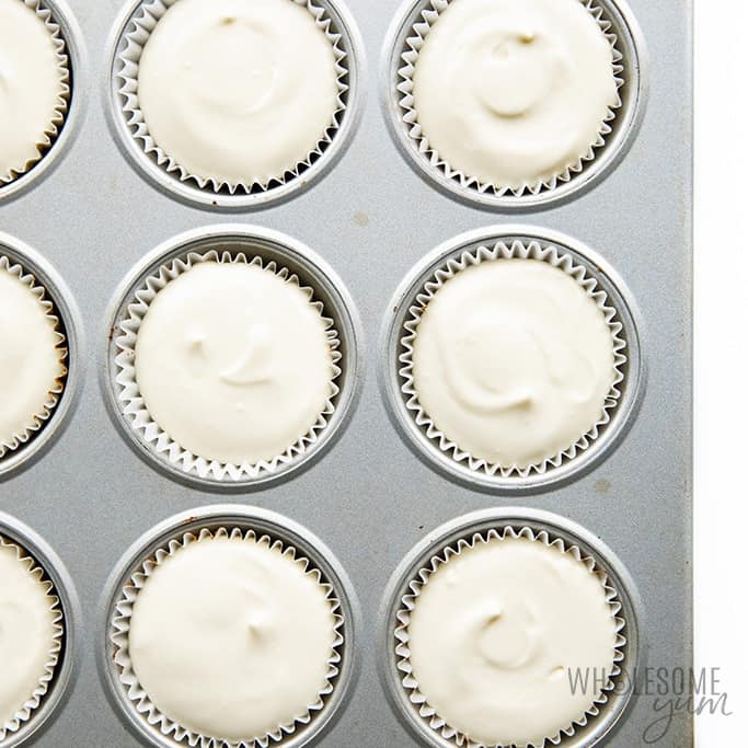 Muffin tin filled with sugar-free mini cheesecake batter.