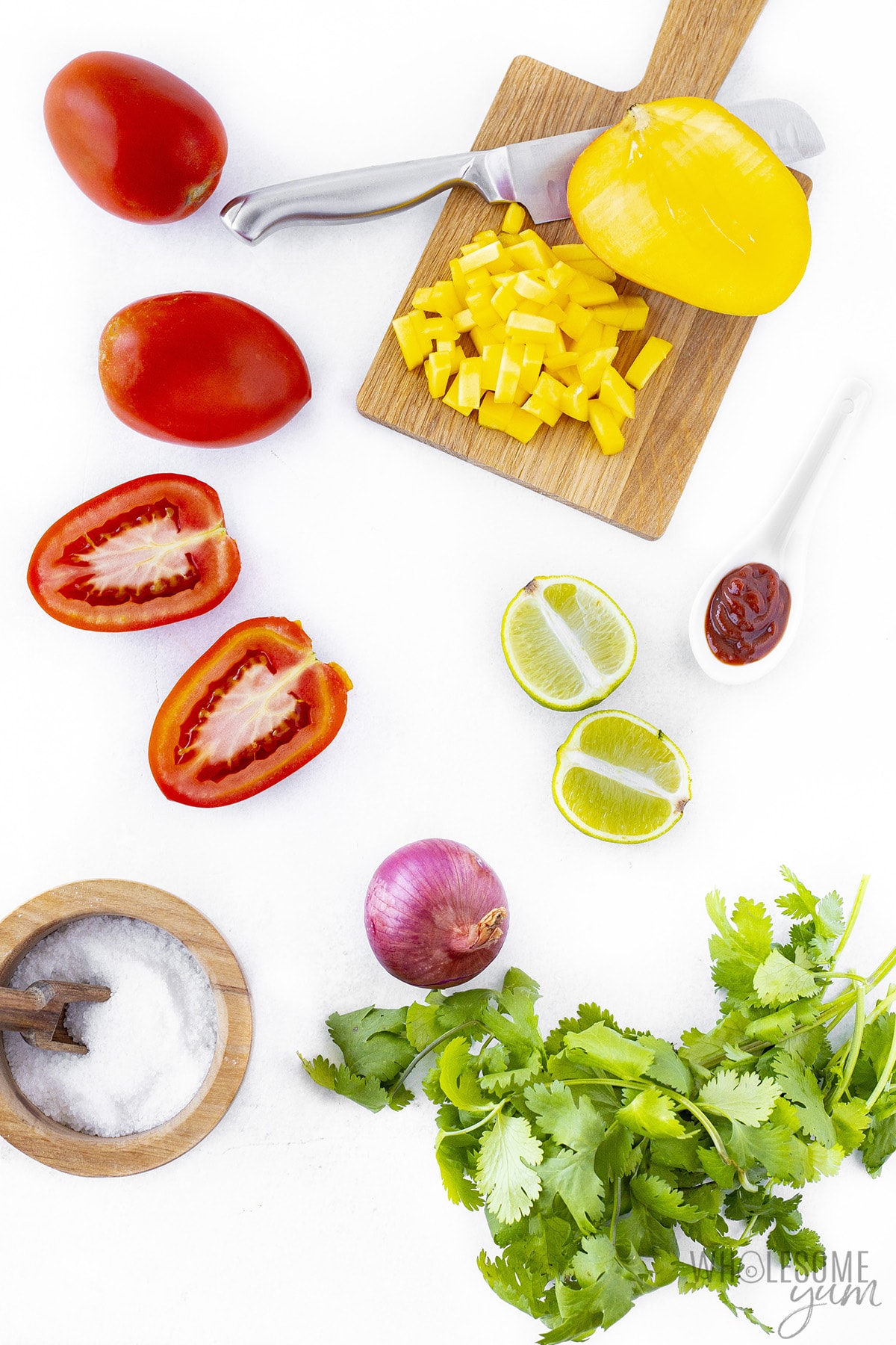 Mango salsa ingredients in bowls and on cutting boards.
