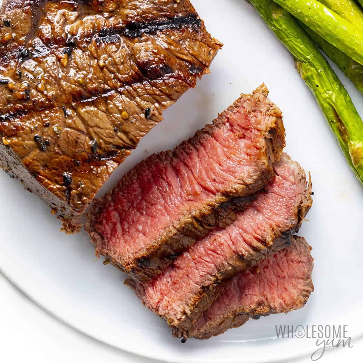 Rested grilled sirloin steak on a plate.