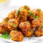 Sausage balls piled on a plate.