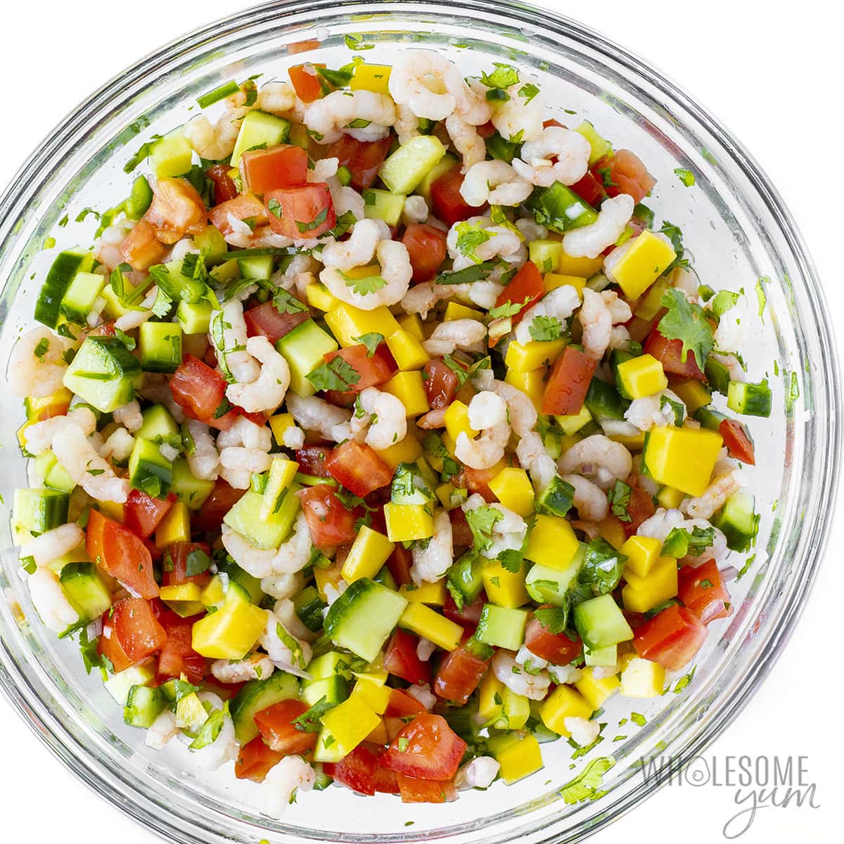 Fully mixed shrimp ceviche recipe in a glass bowl.