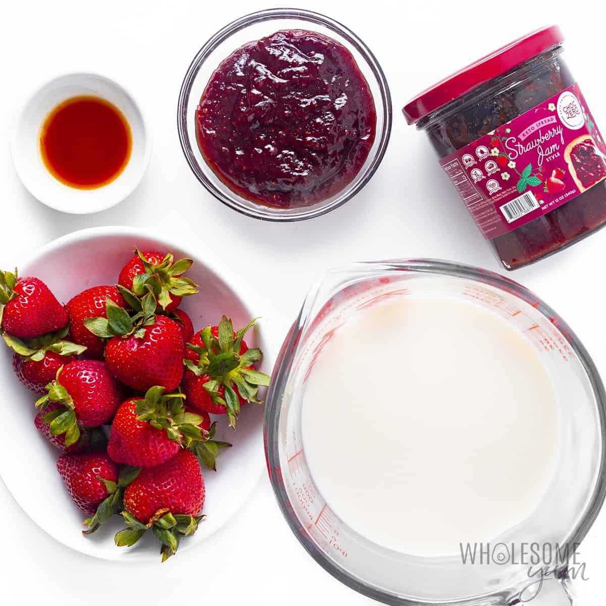 Ingredients for strawberry flavored almond milk in cups and bowls.