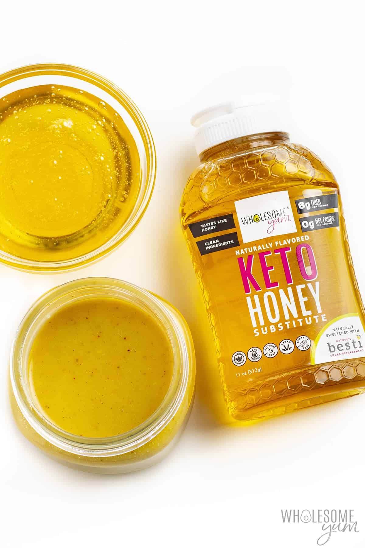 Keto honey mustard next to bottle of Wholesome Yum Keto Honey.