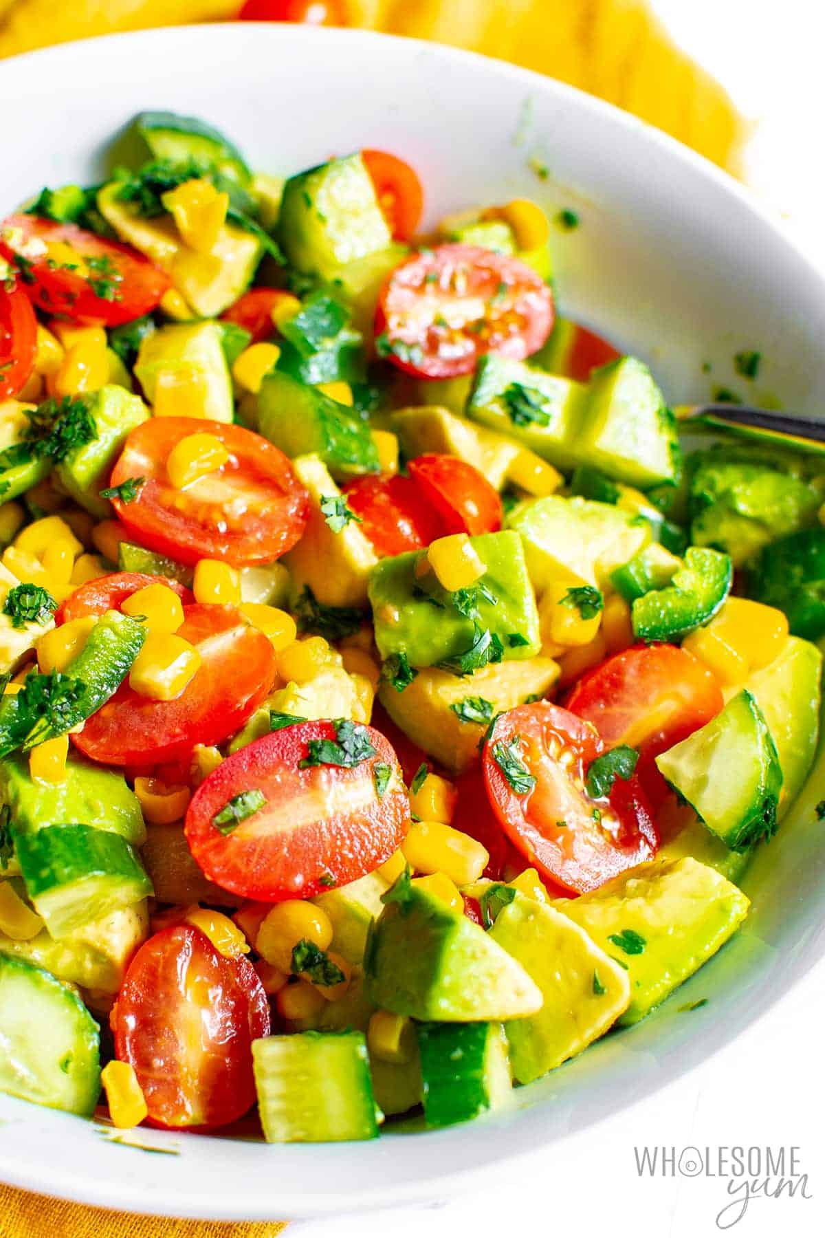Finished fresh avocado corn salad in a bowl.