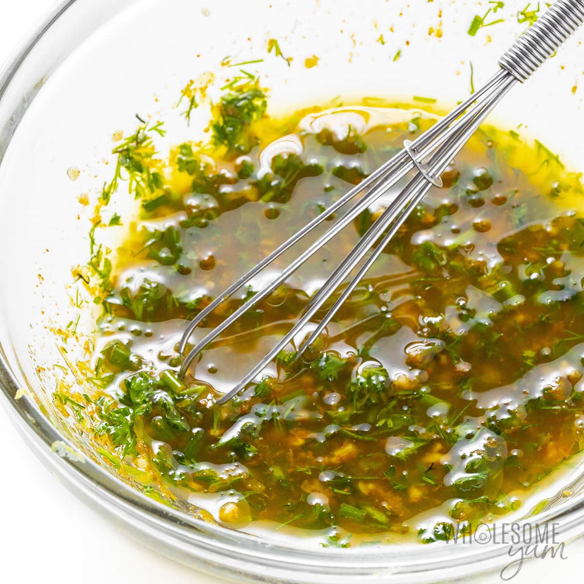 Whisked olive oil and seasonings in a small bowl.