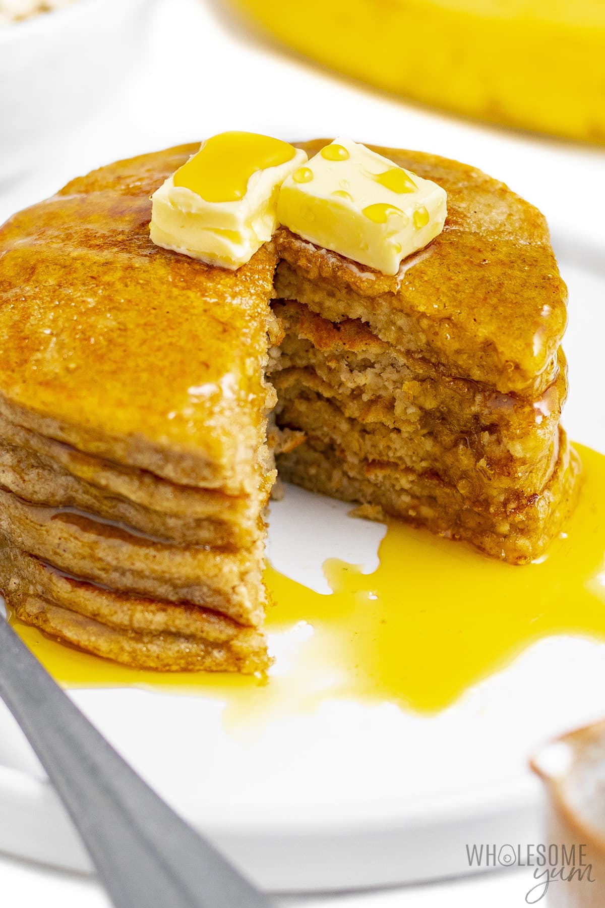 Stack of oat banana pancakes with slice cut out.
