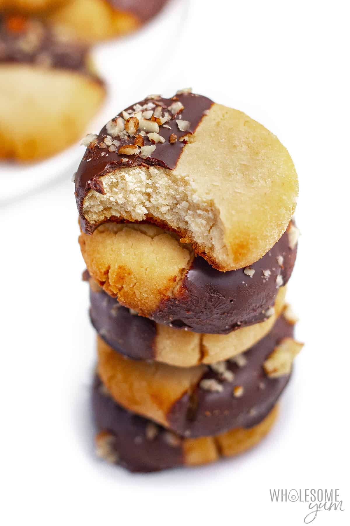 Stack of cookies with one bite taken out of top cookie.